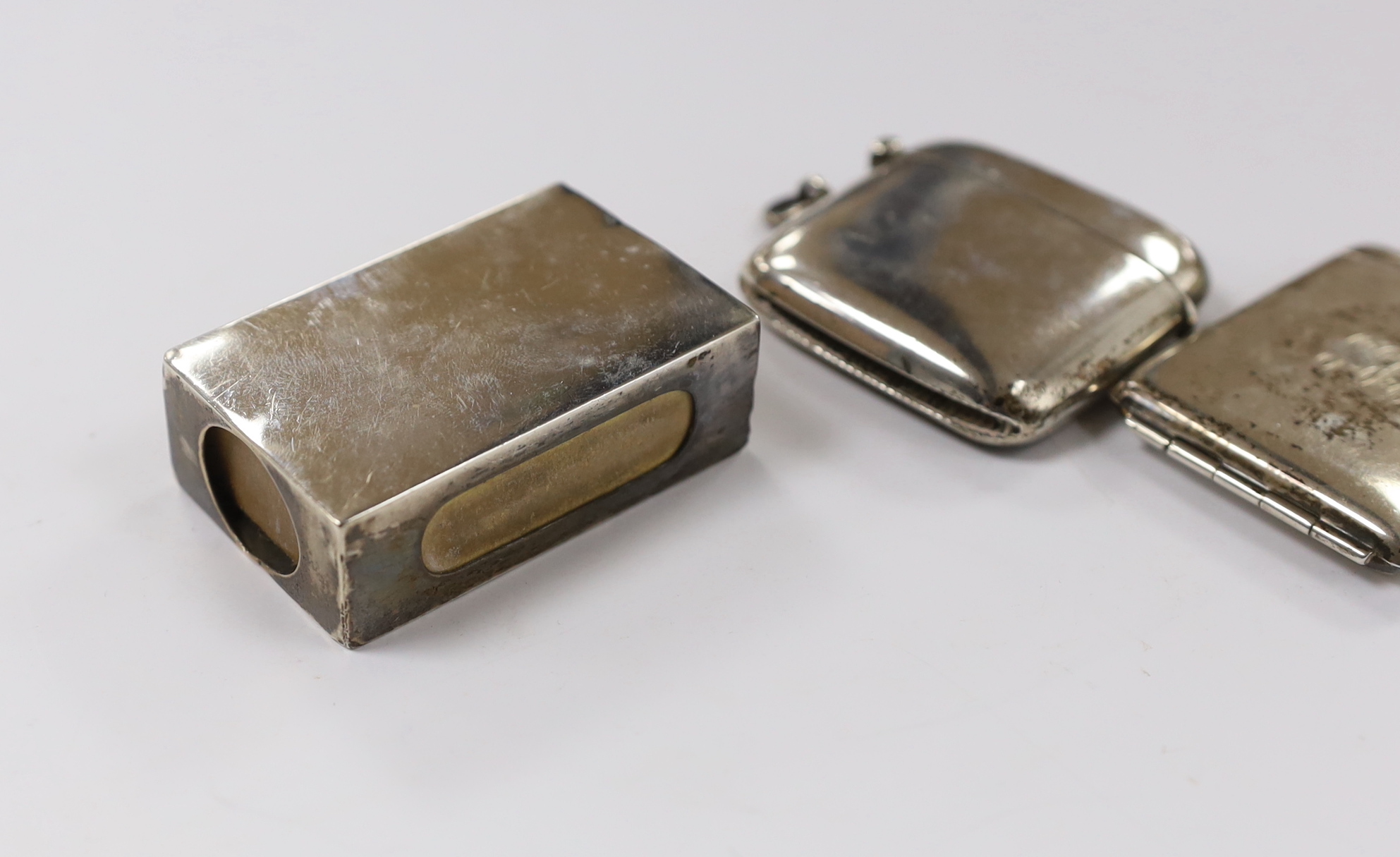 Two silver vesta cases, largest 49mm and two silver match sleeves.